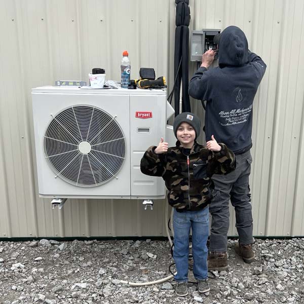 Heat pump installed by Above All Mechanicals. Boy gives thumbs up - Air Conditioning Repair and Installation In Bardstown, KY | Above All Mechanical