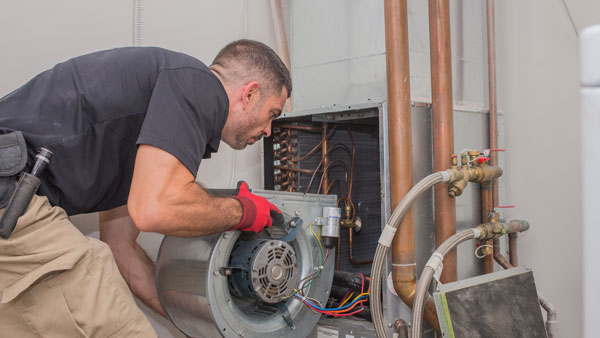 man repairing in home heating - HVAC Techs | Above All Mechanical