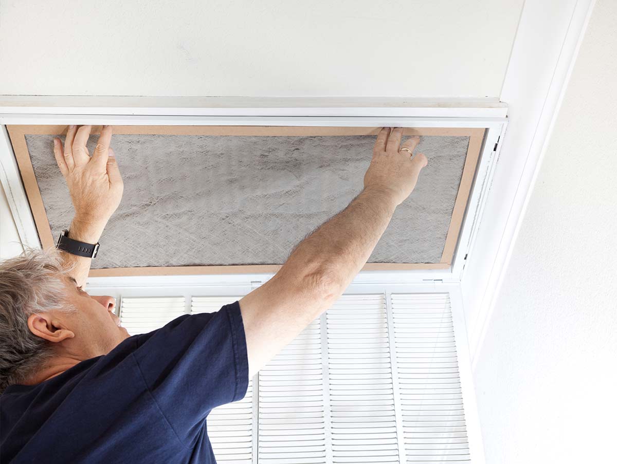 man changes whole house air filter - Air Conditioning Repair and Installation In Bardstown, KY | Above All Mechanical