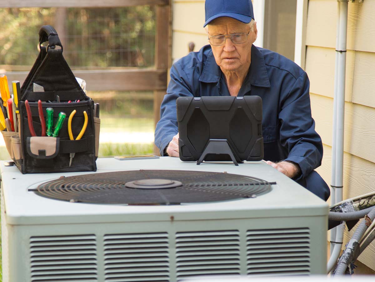 tech runs diagnostics test on hvac system - Air Conditioning Repair and Installation In Bardstown, KY | Above All Mechanical