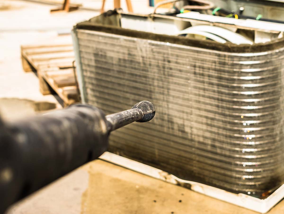 serviceman repairs air handler - Air Conditioning Repair and Installation In Bardstown, KY | Above All Mechanical