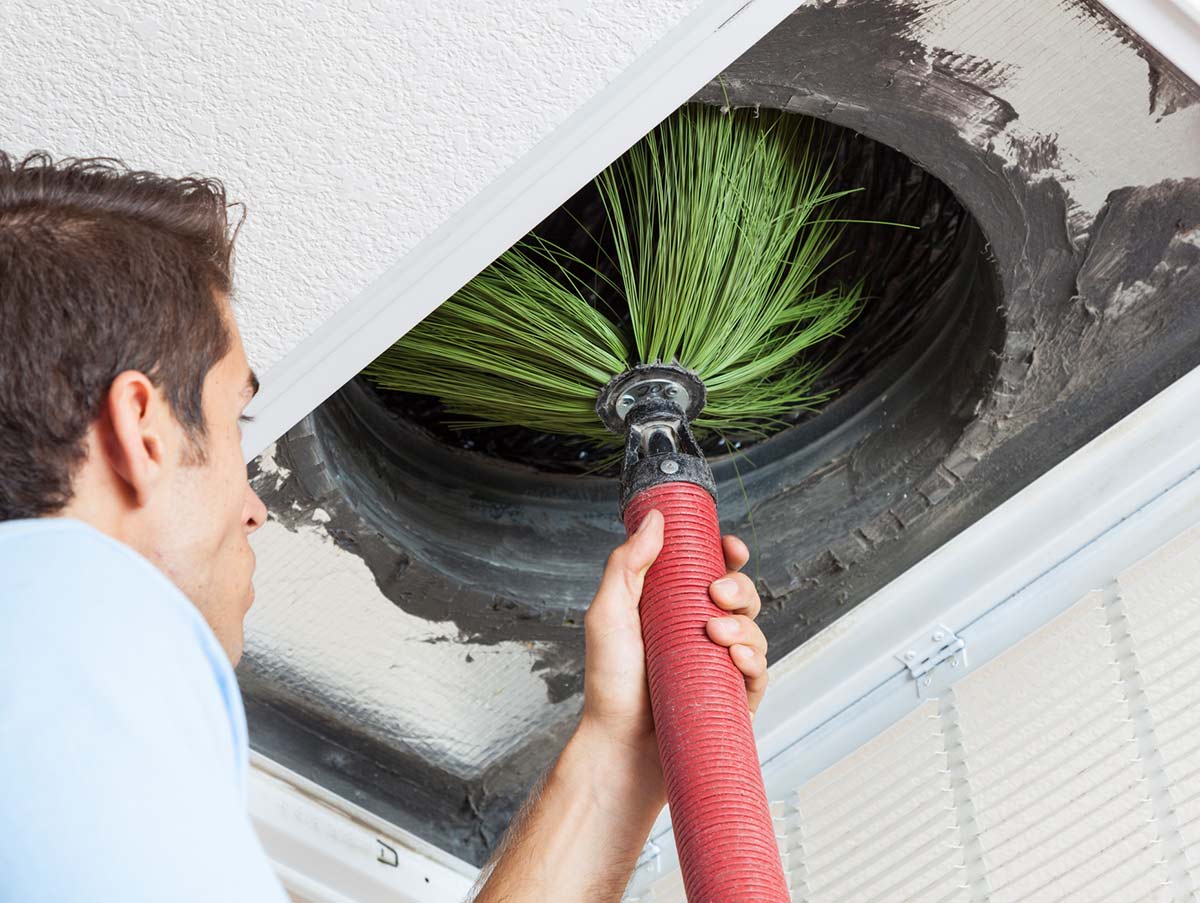 a tech cleans the air vents - Ductwork Repair and Installation In Bardstown, KY | Above All Mechanical